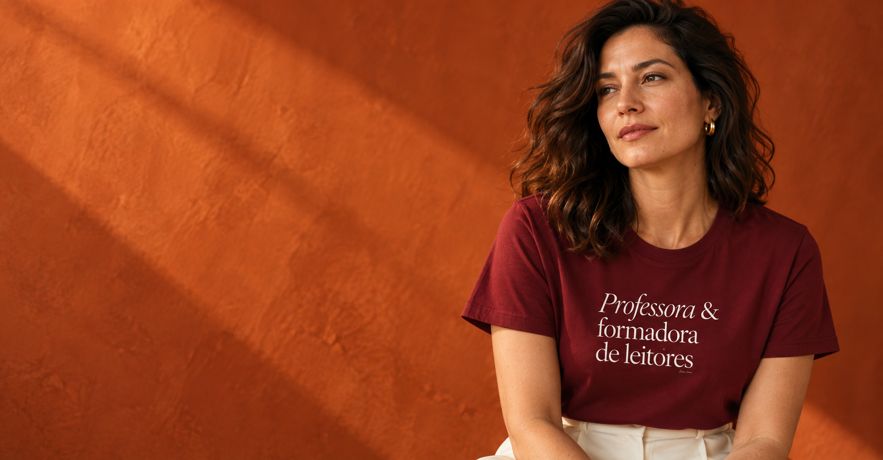 Professora usando camiseta Literalices em cenário laranja